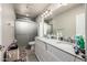 Bathroom featuring vanity with double sinks, large mirror, and walk-in shower at 253 N Fraser Dr, Mesa, AZ 85203