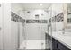 Updated bathroom with white subway tile, decorative tile accent and a frameless glass shower enclosure at 253 N Fraser Dr, Mesa, AZ 85203