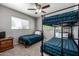 Bedroom with bunk beds, a ceiling fan and a window for natural light at 253 N Fraser Dr, Mesa, AZ 85203