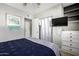 Cozy bedroom with neutral walls, ceiling fan and a closet for storage at 253 N Fraser Dr, Mesa, AZ 85203
