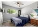 Comfortable bedroom featuring neutral walls, a ceiling fan and a window that provides natural light at 253 N Fraser Dr, Mesa, AZ 85203