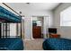 Bedroom with bunk beds, closet, and dresser for ample storage space at 253 N Fraser Dr, Mesa, AZ 85203