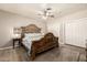 Bedroom with unique wooden bed frame, ceiling fan, and closet space at 253 N Fraser Dr, Mesa, AZ 85203
