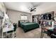 Cozy bedroom with fan, window, desk, and closet with clothing at 253 N Fraser Dr, Mesa, AZ 85203