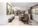 Spacious dining room with decorative wainscotting and art, leading into the kitchen at 253 N Fraser Dr, Mesa, AZ 85203
