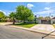 Attractive single-story home featuring well-manicured lawn and gated driveway at 253 N Fraser Dr, Mesa, AZ 85203