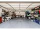 Spacious garage with ample storage, shelving and room for a work area at 253 N Fraser Dr, Mesa, AZ 85203