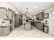 Bright kitchen with tiled flooring, gray cabinetry, granite counters, and stainless appliances at 253 N Fraser Dr, Mesa, AZ 85203
