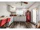 This kitchen offers white cabinets, counter space, and a red retro refrigerator at 253 N Fraser Dr, Mesa, AZ 85203