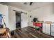 Living area with wood-look flooring, a desk and sliding barn door at 253 N Fraser Dr, Mesa, AZ 85203