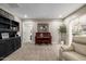 Cozy living room with neutral carpet, a piano, and a black bookshelf at 253 N Fraser Dr, Mesa, AZ 85203