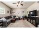 Relax in this living room with a gray sofa, a ceiling fan, and a flat screen television at 253 N Fraser Dr, Mesa, AZ 85203