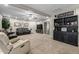 Comfortable living room with neutral carpet, a ceiling fan, and a built-in bookshelf at 253 N Fraser Dr, Mesa, AZ 85203