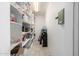 Walk-in pantry with ample shelving for storage, alongside a water cooler at 253 N Fraser Dr, Mesa, AZ 85203