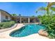 Backyard pool with beautiful landscaping, perfect for relaxation and entertainment at 253 N Fraser Dr, Mesa, AZ 85203
