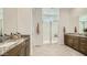Spacious bathroom featuring double vanities, granite countertops, and a glass enclosed walk-in shower at 2877 E Lucky Horseshoe Ln, San Tan Valley, AZ 85140