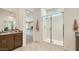 Bright bathroom featuring a glass shower and granite countertops that highlight the contemporary design at 2877 E Lucky Horseshoe Ln, San Tan Valley, AZ 85140
