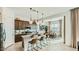 Stylish kitchen featuring stainless steel appliances, granite countertops, and an island with bar seating, open to dining area at 2877 E Lucky Horseshoe Ln, San Tan Valley, AZ 85140