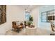 Comfortable sitting room boasts large windows, stylish leather chairs, and modern accents throughout the space at 2877 E Lucky Horseshoe Ln, San Tan Valley, AZ 85140