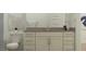 Clean bathroom showcasing vanity with a neutral countertop, stylish fixtures, and a modern toilet at 2897 E Lucky Horseshoe Ln, San Tan Valley, AZ 85140