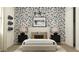 Stylish bedroom featuring a bed with patterned wallpaper and unique skateboard decorative wall art at 2897 E Lucky Horseshoe Ln, San Tan Valley, AZ 85140
