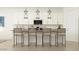 Kitchen featuring an island with seating, modern pendant lighting, and stainless appliances at 2897 E Lucky Horseshoe Ln, San Tan Valley, AZ 85140