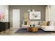 Cozy living room featuring a modern sofa, stylish coffee table, and contemporary art at 2897 E Lucky Horseshoe Ln, San Tan Valley, AZ 85140