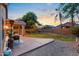 Expansive backyard with a covered patio, lush lawn, and mature trees at 300 W Cardinal Way, Chandler, AZ 85286