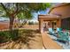 Cozy covered patio with comfortable seating and lush landscaping for serene outdoor living at 300 W Cardinal Way, Chandler, AZ 85286