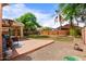 Backyard featuring covered patio, mature trees, lawn, and block fencing at 300 W Cardinal Way, Chandler, AZ 85286
