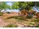 Lush backyard with covered patio, lawn, and mature landscaping, providing a private oasis at 300 W Cardinal Way, Chandler, AZ 85286
