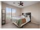 Cozy bedroom features a ceiling fan and a window overlooking the neighborhood at 300 W Cardinal Way, Chandler, AZ 85286