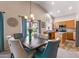 Dining room featuring a wooden table, stylish chairs, and a view of the kitchen and backyard at 300 W Cardinal Way, Chandler, AZ 85286