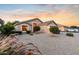 Charming single-story home with desert landscaping and a welcoming entrance at sunset at 300 W Cardinal Way, Chandler, AZ 85286