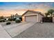 Attached garage with a wide driveway and low-maintenance desert landscaping at 300 W Cardinal Way, Chandler, AZ 85286
