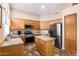 Bright kitchen with stainless steel appliances, wood cabinets, and a center island for meal prep at 300 W Cardinal Way, Chandler, AZ 85286