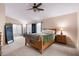 Spacious primary bedroom boasts a ceiling fan and lots of natural light from large window at 300 W Cardinal Way, Chandler, AZ 85286