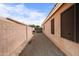 Gravel side yard surrounded by block wall and home exterior offering privacy and low maintenance at 300 W Cardinal Way, Chandler, AZ 85286