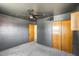 Bedroom featuring dark gray walls, ceiling fan and access to a full closet at 3001 N 21St Ave, Phoenix, AZ 85015