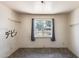 Empty bedroom features a large window, wall with Japanese-like graffiti and carpeted floor at 3001 N 21St Ave, Phoenix, AZ 85015
