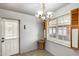 Charming dining area featuring a chandelier and window with shutters; tiled floor at 3001 N 21St Ave, Phoenix, AZ 85015