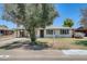Charming single-story home with a well-manicured front yard and a covered carport at 3001 N 21St Ave, Phoenix, AZ 85015