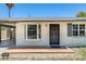 Home exterior featuring a front entrance with security door and carport access at 3001 N 21St Ave, Phoenix, AZ 85015