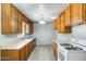 Spacious kitchen featuring ample counter space, wooden cabinets, tiled floors, and modern appliances at 3001 N 21St Ave, Phoenix, AZ 85015