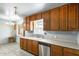 Well-lit kitchen featuring wood cabinets, countertops, stainless steel dishwasher and kitchen chandelier at 3001 N 21St Ave, Phoenix, AZ 85015