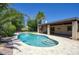 Lush backyard featuring a sparkling pool, mature palm trees, and a covered patio for ultimate outdoor enjoyment at 3009 W Christy Dr, Phoenix, AZ 85029