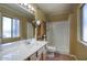 Bathroom features a vanity with white countertop, a mirror, and a shower at 3009 W Christy Dr, Phoenix, AZ 85029