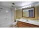 Well-lit bathroom featuring a shower-tub combination and a vanity with ample counter space and storage at 3009 W Christy Dr, Phoenix, AZ 85029