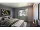 Well-lit bedroom featuring neutral tones, stylish decor, and a large window with neighborhood view at 3009 W Christy Dr, Phoenix, AZ 85029
