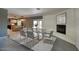 Elegant dining area with a modern table setting, fireplace, and open access to the kitchen at 3009 W Christy Dr, Phoenix, AZ 85029
